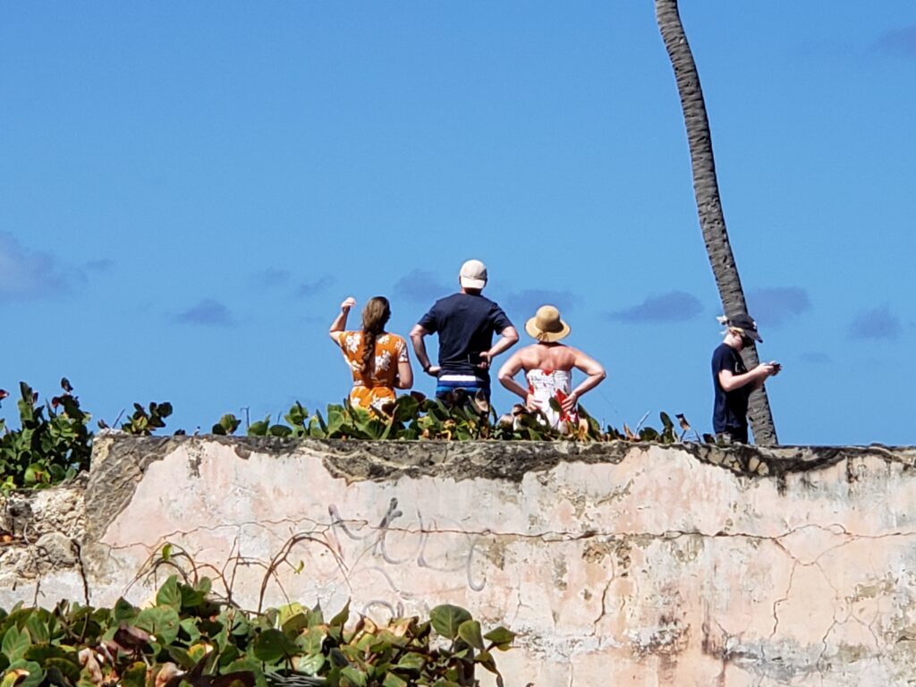 Visitors stand on a cliff in the north of Barbados